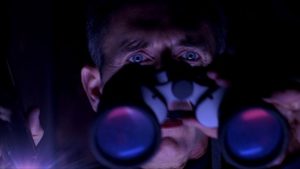 Preston Rogers (Matt McCoy) watches helplessly as a monster stalks the women next door in Ryan Schifrin's Abominable (2005)