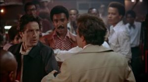 Nicky (John Cassavetes) stirs up conflict with the Black patrons of a bar in Elaine May's Mikey and Nicky (1976)