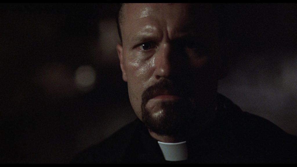 Michael Rooker as an angry demon-fighting priest in Jamie Dixon's Shadowbuilder (1998)