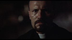 Michael Rooker as an angry demon-fighting priest in Jamie Dixon's Shadowbuilder (1998)