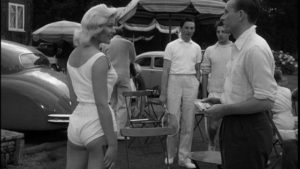 Molly Stevens (Magda Miller) provokes the members of the tennis club in John Guillermin's Town on Trial (1957)