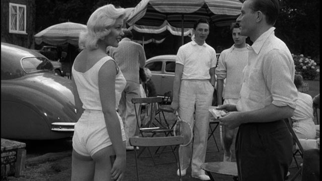 Molly Stevens (Magda Miller) provokes the members of the tennis club in John Guillermin's Town on Trial (1957)