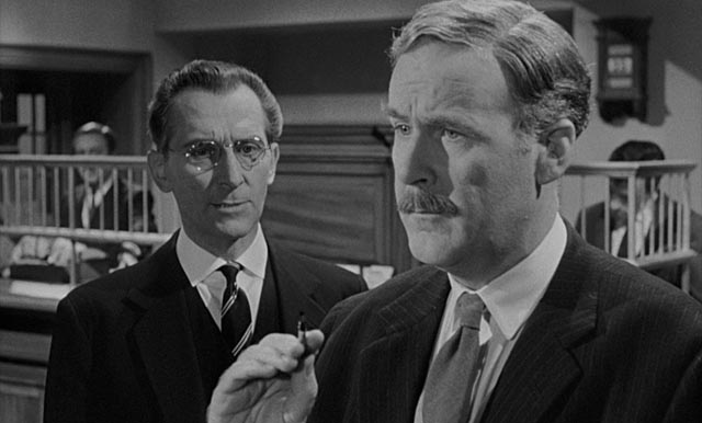 Fordyce (Peter Cushing) bolsters his own fragile ego by intimidating the bank 's chief clerk, Pearson (Richard Vernon) in Quentin Lawrence's Cash on Demand (1961)