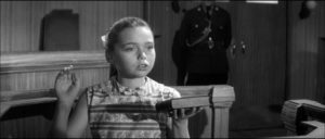 Jean Carter (Janina Faye) takes the stand to testify against the town patriarch in Cyril Frankel's Never Take Sweets from a Stranger (1960)