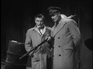 Quatermass (Andre Morrell) and Colonel Breen (Anthony Bushell) examine the strange find at a construction site in Nigel Kneale's Quatermass and the Pit (1959)