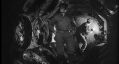 Members of a British Army bomb disposal squad inspect the interior of the alien craft in Nigel Kneale's Quatermass and the Pit (1959)