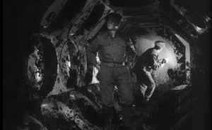 Members of a British Army bomb disposal squad inspect the interior of the alien craft in Nigel Kneale's Quatermass and the Pit (1959)