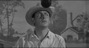 Making his TV debut, Lonesome (Andy Griffith) plays the country bumpkin to mock the medium in Elia Kazan's A Face in the Crowd (1957)