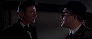 Eberlin (Laurence Harvey) confronts irritating agency bureaucrat Copperfield (Norman Bird) in Anthony Mann's A Dandy in Aspic (1968)