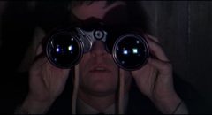 British agent Gatiss (Tom Courtenay) spies on fellow spy Eberlin (Laurence Harvey) in Anthony Mann's A Dandy in Aspic (1968)