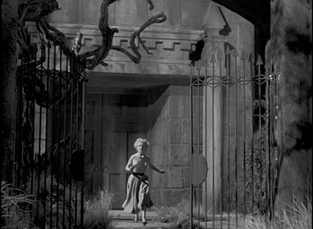 Kitty (Veronica Hurst) runs from the castle in fear in William Cameron Menzies' The Maze (1953)