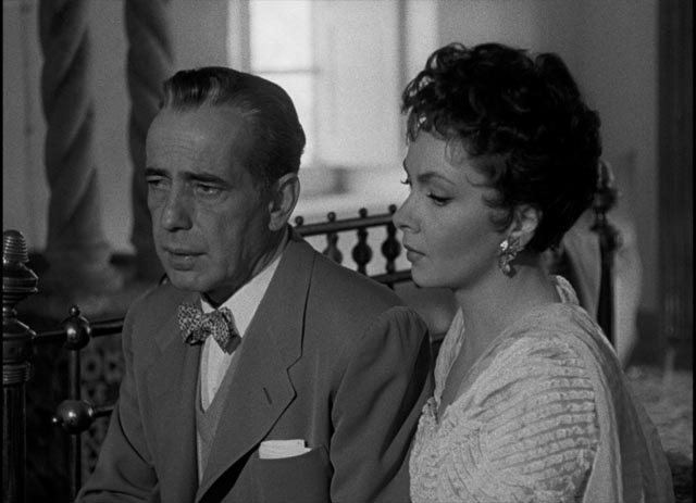 Humphrey Bogart as dissolute expatriate Billy Danreuther with wife Maria (Gina Lollobrigida) in John Huston's Beat the Devil (1953)