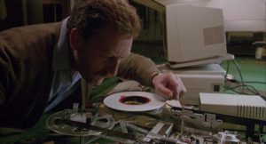 Bernard Hill deciphers a computer tape in Richard Loncraine's Bellman & True (1987)