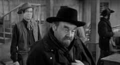 Rancher Blaise Starrett (Robert Ryan) is cautious with Jack Bruhn (Burl Ives) and his violent gang in Andre de Toth's Day of the Outlaw (1959)