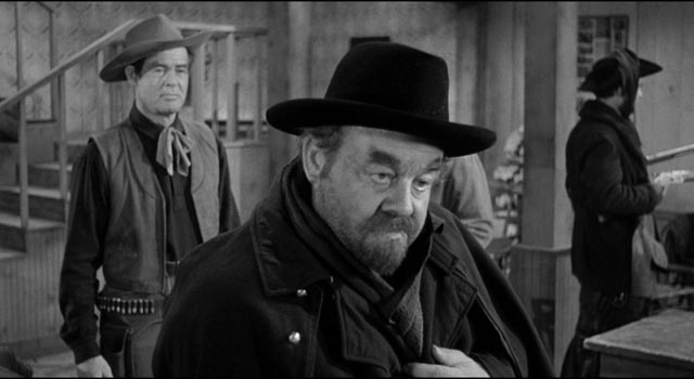 Rancher Blaise Starrett (Robert Ryan) is cautious with Jack Bruhn (Burl Ives) and his violent gang in Andre de Toth's Day of the Outlaw (1959)