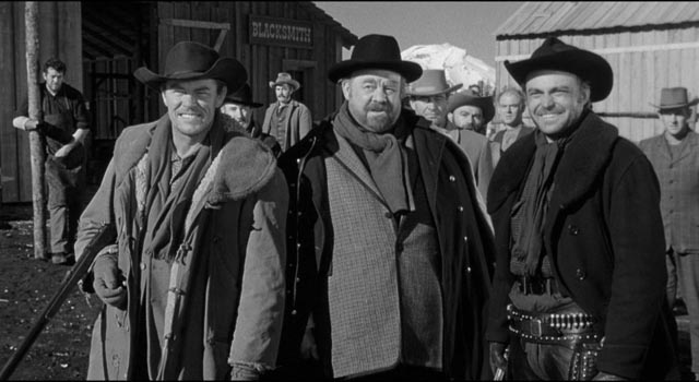 The gang prepare to teach Starrett (Robert Ryan) a lesson with a brutal beating in Andre de Toth's Day of the Outlaw (1959)