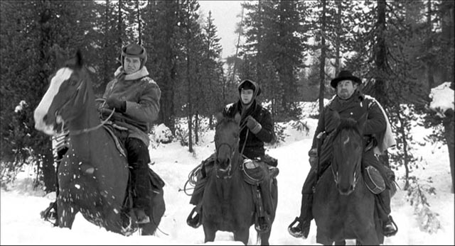 Starrett (Robert Ryan) leads Bruhn (Burl Ives)'s gang into a deadly wilderness in Andre de Toth's Day of the Outlaw (1959)