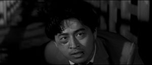 Reporter Hiroyuki Nagato risks his life for a story in Seijun Suzuki's Smashing the O-Line (1960)
