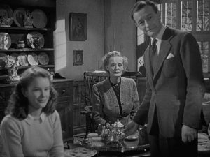 House-owner Elliot Foley (Roland Culver) and his guests are drawn into Craig (Mervyn Johns)'s nightmare in Ealing's horror anthology Dead of Night (1945)