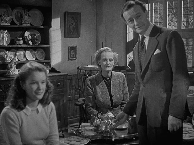House-owner Elliot Foley (Roland Culver) and his guests are drawn into Craig (Mervyn Johns)'s nightmare in Ealing's horror anthology Dead of Night (1945)