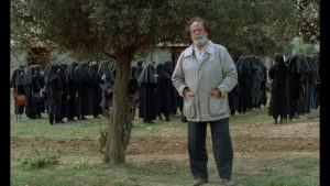 Actor Mohammad Ali Keshavarz introduces himself as the Director of And Life Goes On in Abbas Kiarostami's Through the Olive Trees (1994)
