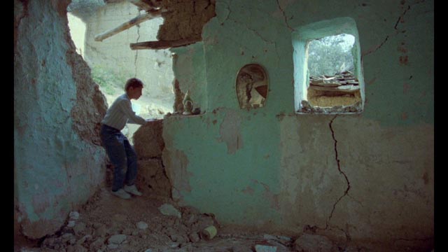 The Director's son Pouya (Pouya Payvar) explores the ruins of Poshteh in Abbas Kiarostami's And Life Goes On (1992)