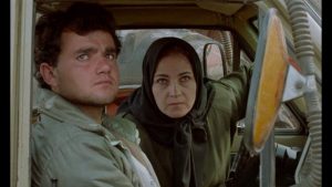 Hossein (Hossein Rezai) is picked up and coached by the Director's assistant Mrs Shiva (Zahrifeh Shiva) in Abbas Kiarostami's Through the Olive Trees (1994)