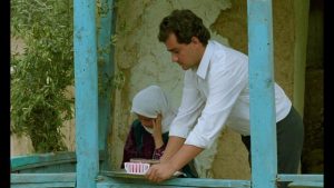 Between takes, Hossein (Hossein Rezai) offers Tahereh (Tahereh Ladanian) tea in Abbas Kiarostami's Through the Olive Trees (1994)