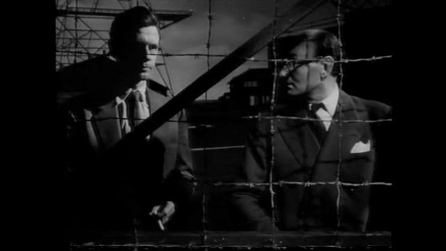 Heathley (James Donald) and project head Professor Carrington (Maurice Denham) disagree on the risks of a test flight in Anthony Asquith's The Net (1953)