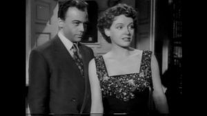 Team member Alex Leon (Herbert Lom) hopes to take Heathley (James Donald)'s place in Lydia (Phyllis Calvert)'s affections in Anthony Asquith's The Net (1953)
