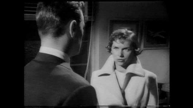 Caroline Cartier (Muriel Pavlov) warns Brian Johnson (Patric Doonan) that Heathley (James Donald)'s obsession is dangerous in Anthony Asquith's The Net (1953)