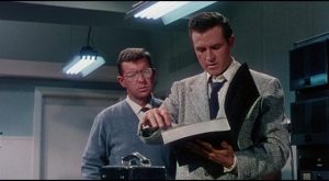Cal Meacham (Rex Reason) is intrigued by the mysterious tech catalogue in Joseph Newman's This Island Earth (1955)