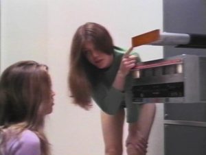 Isa (Caroline Hildebrand) explains the time machine's controls to her sister Karen (Kelley Bohanon) in Peter Fonda's Idaho Transfer (1973)