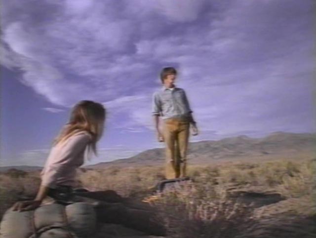 Karen (Kelley Bohanon) and Ronald (Kevin Hearst) search for signs of human survival in Peter Fonda's Idaho Transfer (1973)