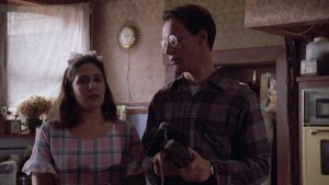 Dennis (Ted Raimi) finds a degree of normalcy with unhappily married Kerry Tate (Ricki Lake) in Ivan Nagy's Skinner (1993)