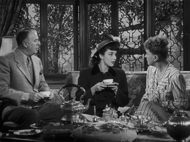 Sir Henry Carmel (Reginald Owen) and Lady Alice (Margaret Bannerman) mistake Cluny (Jennifer Jones) for one of their own class in Ernst Lubitsch's Cluny Brown (1946)
