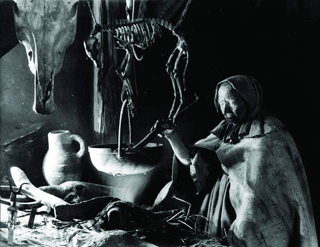 Brewing potions in a witch's kitchen in Benjamin Christensen's Haxan (1922)