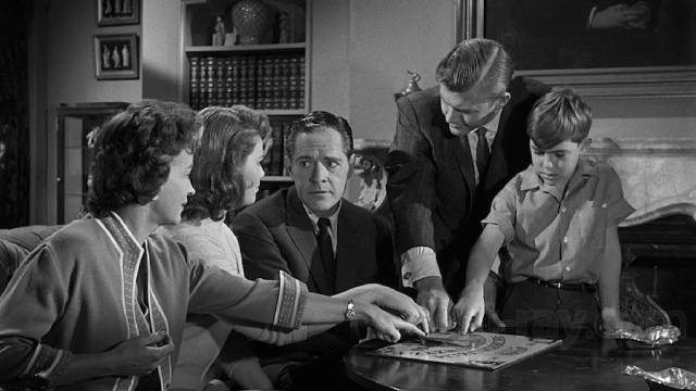 The Zorba family (Donald Woods, Rosemary DeCamp, Jo Morrow and Charles Herbert) and lawyer Rush (Martin Milner) try out the Ouija board in William Castle's 13 Ghosts (1960)