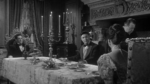 Dr. Cargrave (Ronald Lewis) has an uneasy meal with the Baron (Guy Rolfe) and Maude (Audrey Dalton) in William Castle's Mr. Sardonicus (1961)