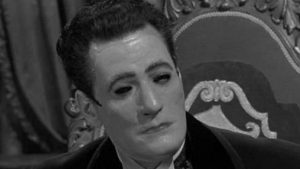 The Baron (Guy Rolfe) conceals his rigid features behind a mask in William Castle's Mr. Sardonicus (1961)