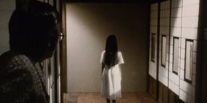 Sadako (Rie Ino'o) standing still with long hair and back turned evokes menace and mystery in Norio Tsuruta's Ring 0 (2000)