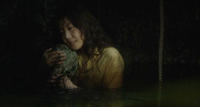 Reiko (Nanako Matsushima) comforts the rotting remains of Sadako at the bottom of the well in Hideo Nakata's Ringu (1998)