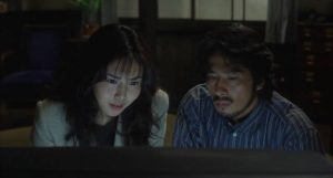 Reiko (Nanako Matsushima) shows ex-husband Ryuji (Hiroyuki Sanada) the cursed tape in Hideo Nakata's Rinhu (1998)