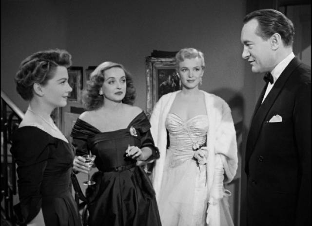 Addison DeWitt (George Sanders) arrives at the party with his young protege Miss Caswell (Marilyn Monroe) in Joseph L. Mankiewicz's All About Eve (1950)