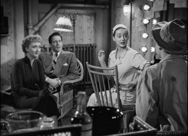 Margot (Bette Davis), Lloyd Richards (Hugh Marlowe) and Karen (Celeste Holm) are enthralled by Eve (Anne Baxter)'s sad life story in Joseph L. Mankiewicz's All About Eve (1950)