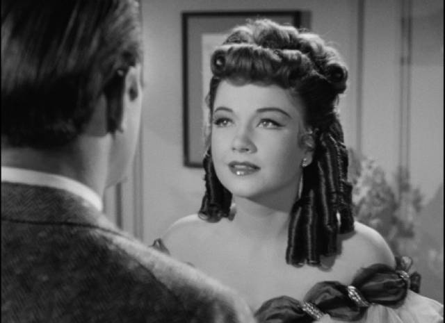 At her moment of triumph, Eve (Anne Baxter) discovers the power Addison (George Sanders) has over her in Joseph L. Mankiewicz's All About Eve (1950)