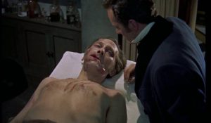 Critically injured by his victims, the Baron (Peter Cushing) is in need of urgent repair in Terence Fisher's The Revenge of Frankenstein (1958)