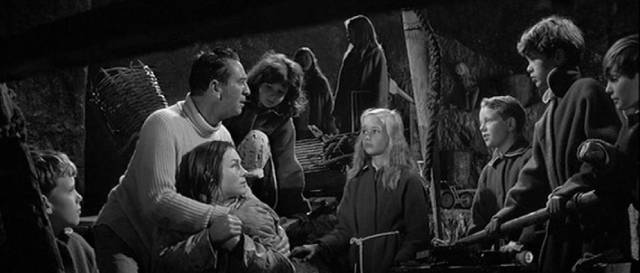 Simon (Macdonald Carey) and Joan (Shirley Anne Field) discover the strange children in their secret cave in Joseph Losey's The Damned (1962)