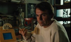 Claire (Solveig Dommartin)'s lover Eugene (Sam Neill) begins writing her story in Paris in Wim Wenders' Until the End of the World (1991)