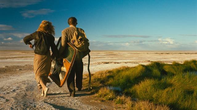 Claire (Solveig Dommartin) and Sam (William Hurt) set off across the desert on foot after their forces landing in Wim Wenders' Until the End of the World (1991)